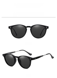 Detail view of black vintage polarized sunglasses with silver rivets and metal hinges
