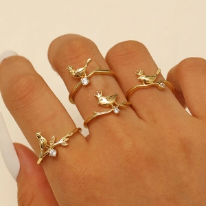 Creative gold bird and branch ring set with crowns and zircons worn on hand
