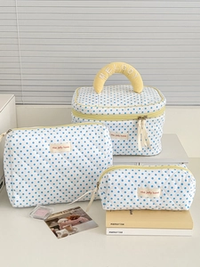 Three-piece quilted cotton cosmetic bag set with blue polka dots and yellow accents