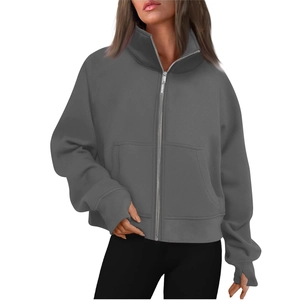 Detailed view of dark grey fleece sweatshirt featuring thumb hole cuffs and a tall stand collar