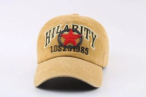 Detail of washed cotton baseball cap featuring red star embroidery and Hilarity text