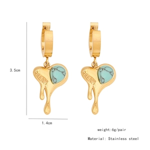Detailed view of heart-shaped stainless steel earrings with turquoise and DREAM engraving