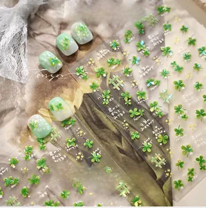 Macro detail of green four-leaf clover nail stickers with cute stars and grid patterns