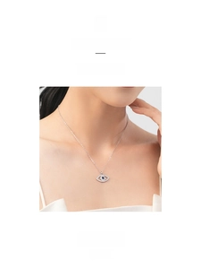 Close-up of S925 sterling silver evil eye necklace with blue gem and white diamonds