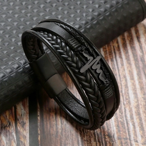 Detail of black multi-layer leather bracelet featuring an ECG heartbeat metal charm