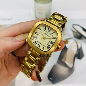 Close-up of elegant gold square watch with roman numerals and metallic strap on wrist