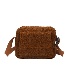 Brown faux shearling crossbody bag with adjustable strap and front flap pocket on white background