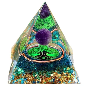 Orgone pyramid with amethyst ball, tree of life, and blue crystals on white background
