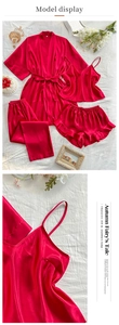 Flat lay of red satin four-piece sleepwear set including robe, camisole, shorts, and pants