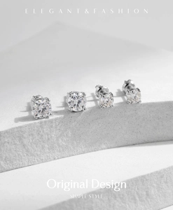 Macro shot of four-prong round moissanite earrings in S925 sterling silver set on stone