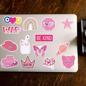 Pink VSCO stickers with butterfly and rainbow patterns on a laptop cover