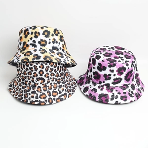 Close-up of leopard print bucket hats in yellow, orange, and purple color options