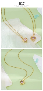 Detailed macro view of heart pendant necklace with pink zircon in gold setting