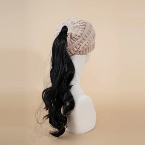 Detail of beige knit beanie with top opening for ponytail styled on model head