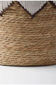 Close-up of natural seagrass weave pattern with white cotton diamond embroidery
