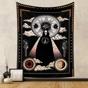 Detail of gothic skull tapestry with mystic sun and moon elements on beige wall