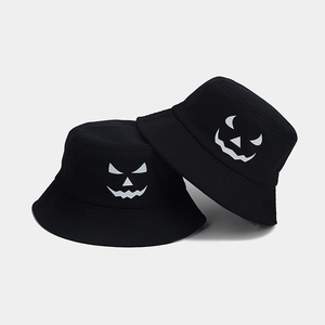 Black cotton bucket hats featuring luminous Halloween pumpkin face patterns for adults
