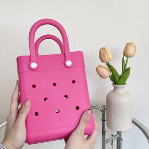 Macro detail of Fuchsia EVA beach tote bag featuring breathable holes and matching handles