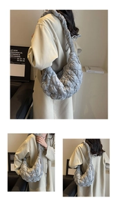 Detail of the gray quilted crescent bag showing its soft texture and ruched stitching