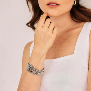 Minimalist multi-layer beaded birthstone bracelet with colorful rectangular gems on a model