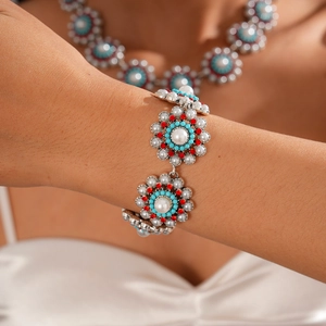 Detail of vintage flower bracelet with pearls, colorful rhinestones and turquoise beads