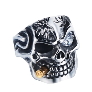 Punk silver and gold skull ring with clear cubic zirconia eye and bullet detail