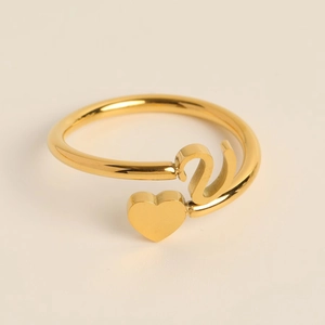 Close-up of golden adjustable heart ring with polished finish and asymmetric design