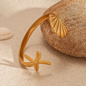 2-piece gold stainless steel cuff bracelets with starfish and seashell charms on natural stone