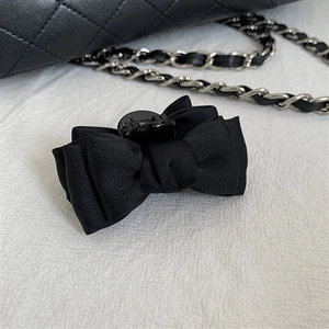 Elegant black satin ribbon hair claw clip for women featuring a layered bow design