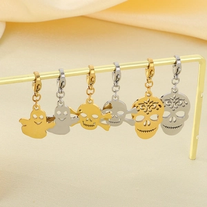 Halloween ghost and skull steel pendants in gold and silver finish on display stand
