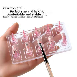 Close-up of pink acrylic nail art stands with butterfly and pearl nail designs