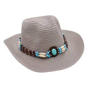 Close-up of woven cowboy hat with turquoise centerpiece and decorative bead band details