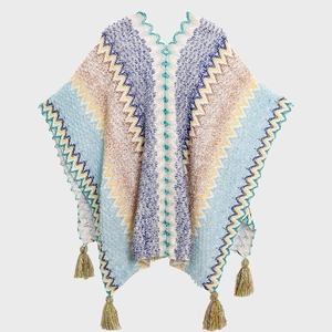 Ethnic knit poncho with colorful zigzag patterns and fringe tassels for travel wear