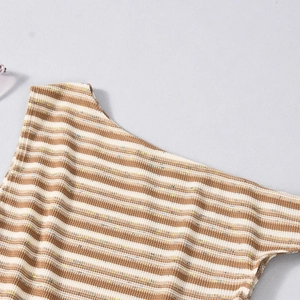 Detailed view of striped knit top fabric featuring brown and beige ribbed cotton texture