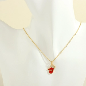 Detail of gold Christmas necklace featuring a red enamel glove pendant with micro-inlaid stones