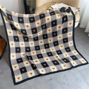Detail showing checkered patterns and brown heart prints on a soft cotton linen scarf shawl