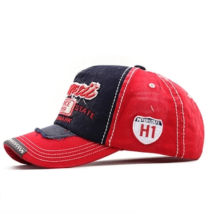 Detail of vintage red and navy baseball cap with 3D embroidery and distressed brim