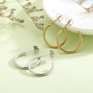 Elegant twisted rope hoop earrings in gold and silver finish with metallic luster