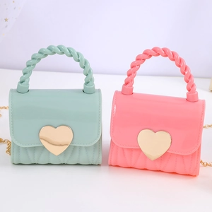 Mini jelly heart handbags in mint green and pink with gold twist handles and chain straps