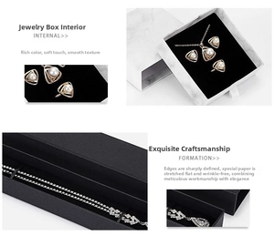 Detail view of drawer-style jewelry boxes with marble pattern and black velvet interior
