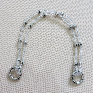 Detail of double-strand crystal bead bag handle with silver spring metal rings