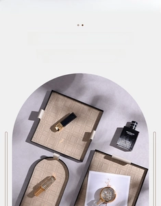 Detail of woven beige leather trays with handles for jewelry and cosmetic organization
