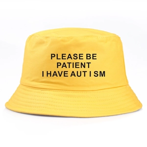 Bright yellow bucket hat featuring PLEASE BE PATIENT I HAVE AUTISM print on cotton fabric