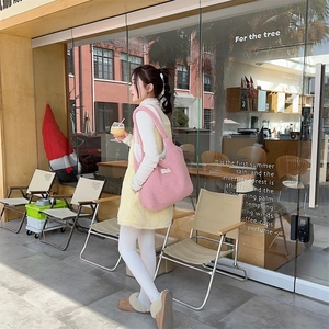 Pink fleece tote bag shown in a lifestyle street shot for autumn winter casual wear
