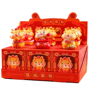 Close-up of Cute Dragon resin figurines set with red and gold festive ornaments