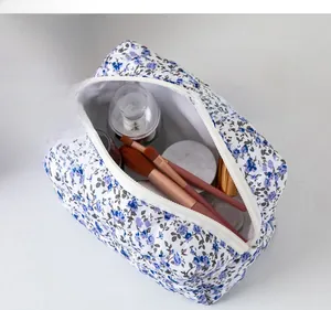 Floral makeup bag showing interior storage capacity with brushes and cosmetics