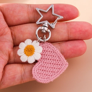 Handheld crochet heart and daisy flower keychain with metal star clip accessory