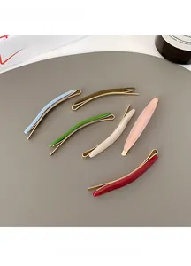 Flat lay of colorful acetate hair clips in six vibrant candy tones with gold metal bases