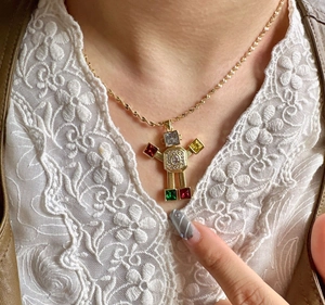 Close-up of golden robot pendant necklace with colorful zircon stones on model