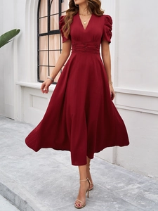 Detail of wine red V-neck dress featuring short puff sleeves and pleated high waist design
